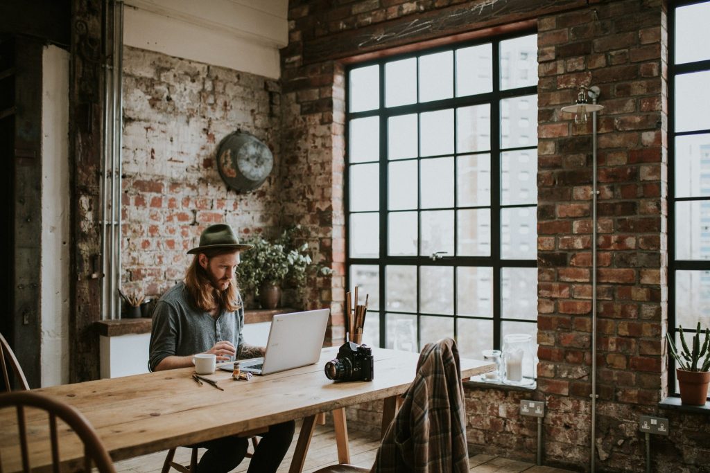 Man working freelance at coffee shop.