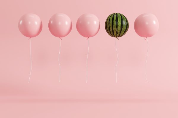 4 pink balloons in contrast with one watermelon balloon