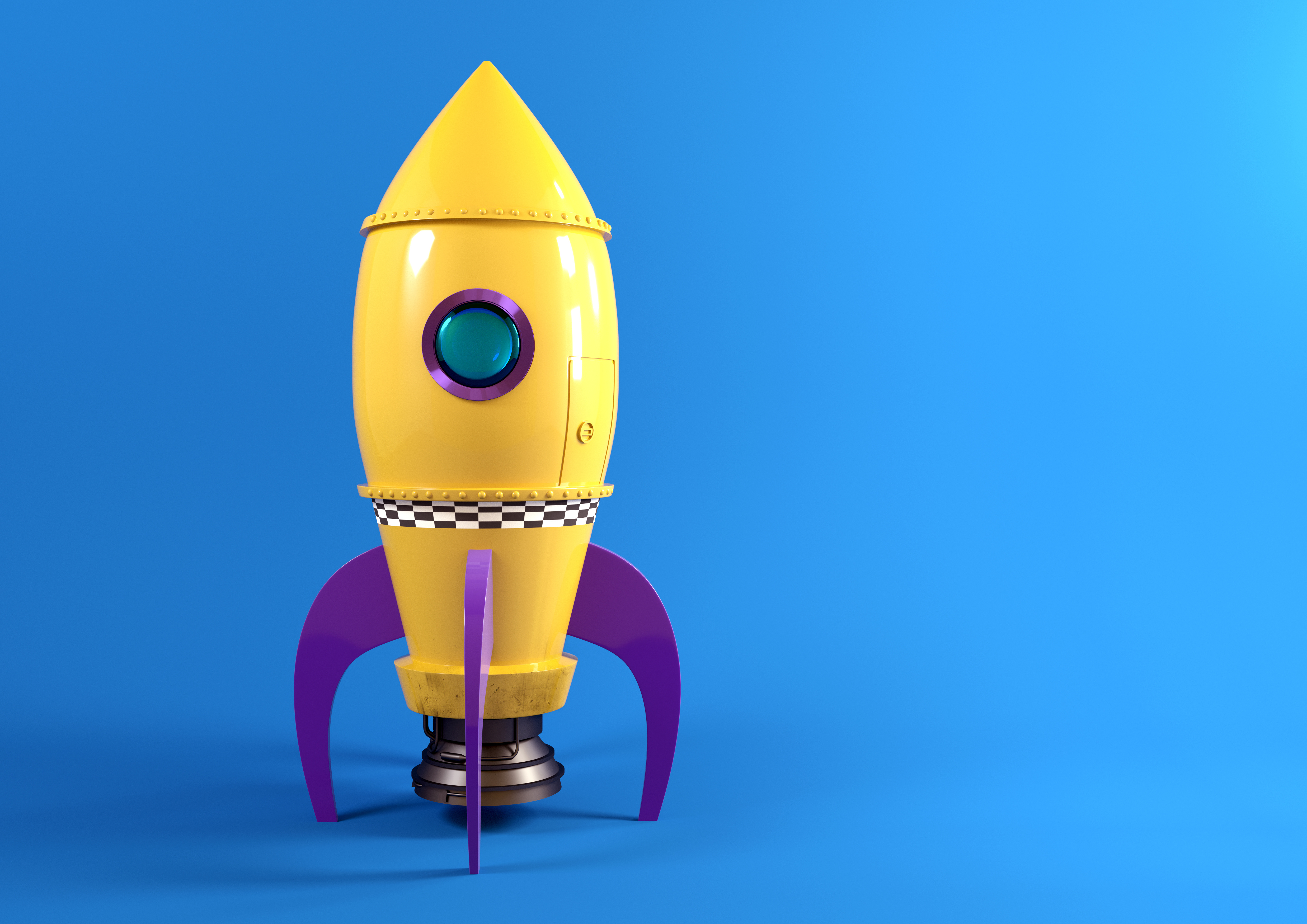 Yellow toy rocketship on blue backdrop