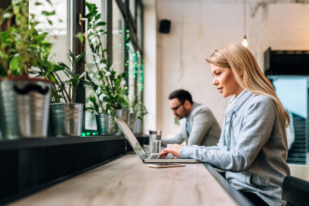 Woman working on her website in a coffee shop