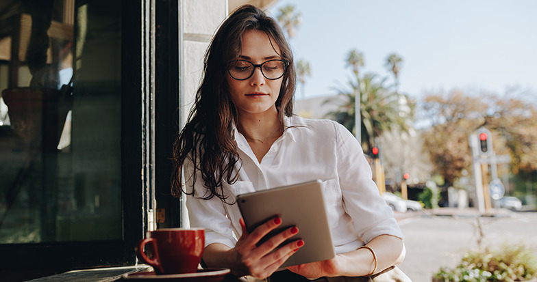 woman reading a newsletter on her ipad