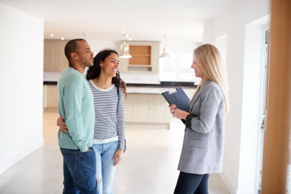 real estate agent talking to a young couple