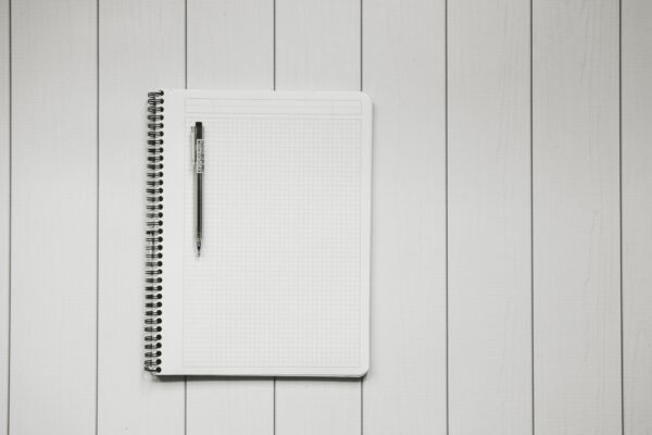 blank page notebook on a white desk