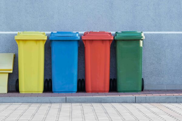 A row of colored trash bins