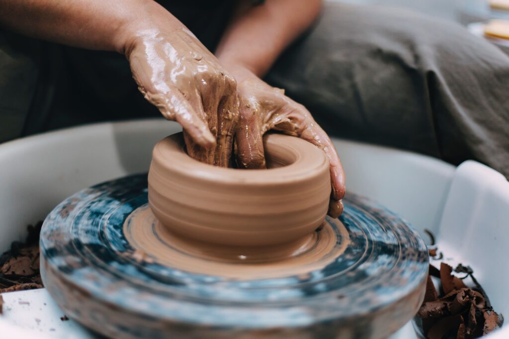 Person working on a pottery wheel - ceramics are a popular item to sell online