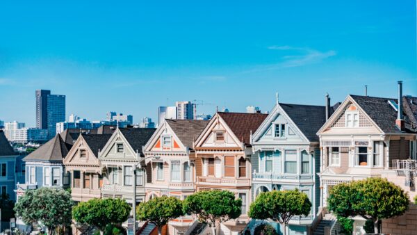 row of homes with trees in front yard