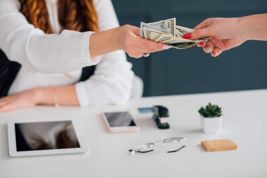 person handing cash to a consultant