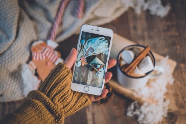 person taking christmas brand photo on iphone