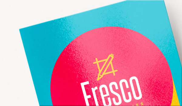 A business card paper example showing a glossy texture, with pink, blue, and yellow branding