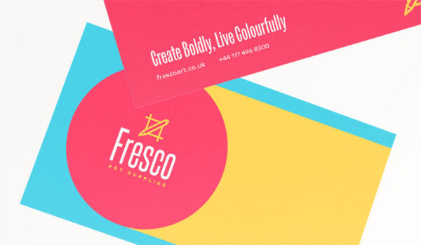 A business card example showing a smooth texture, with pink, blue, and yellow branding